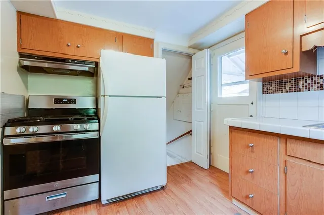 a kitchen with a refrigerator stove and a sink