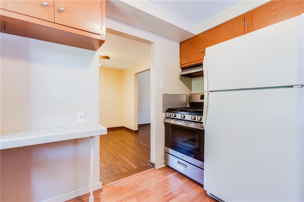 133 Hamburg Street Pittsburgh, PA 15220 - Photo 15 of 41 a kitchen with stainless steel appliances a refrigerator and a stove