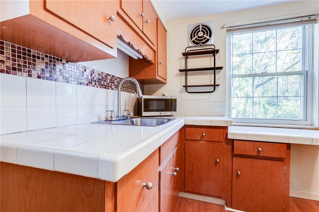 133 Hamburg Street Pittsburgh, PA 15220 - Photo 17 of 41 a kitchen with a refrigerator a stove and a window