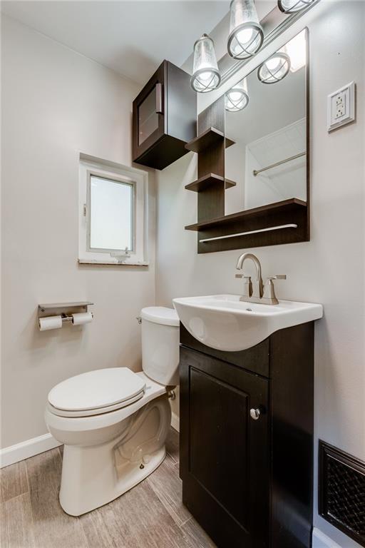 133 Hamburg Street Pittsburgh, PA 15220 - Photo 20 of 41 a bathroom with a toilet sink and mirror