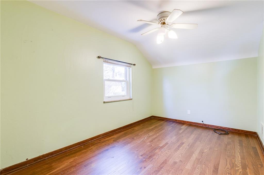 133 Hamburg Street Pittsburgh, PA 15220 - Photo 22 of 41 an empty room with a window and a ceiling fan