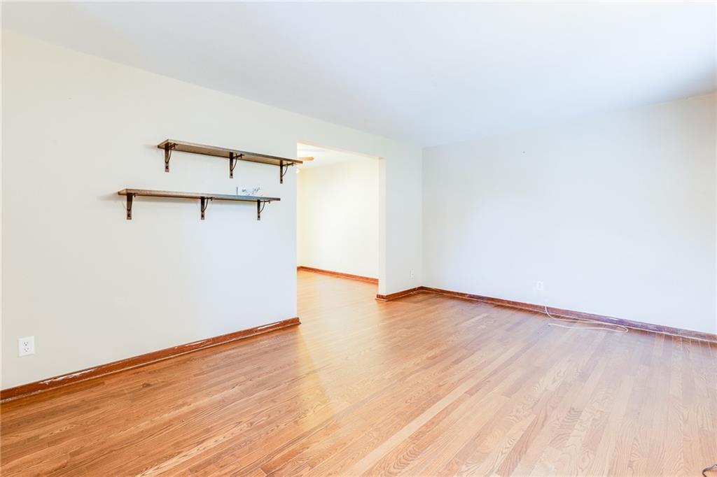 133 Hamburg Street Pittsburgh, PA 15220 - Photo 5 of 41 an empty room with wooden floor and windows