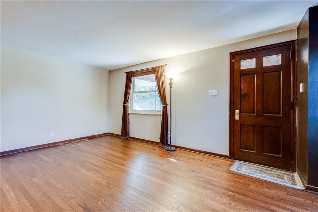 133 Hamburg Street Pittsburgh, PA 15220 - Photo 6 of 41 an empty room with wooden floor closet and mirror
