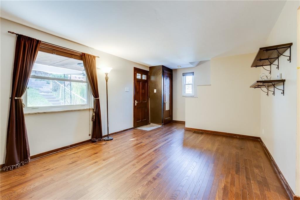133 Hamburg Street Pittsburgh, PA 15220 - Photo 7 of 41 an empty room with wooden floor and windows