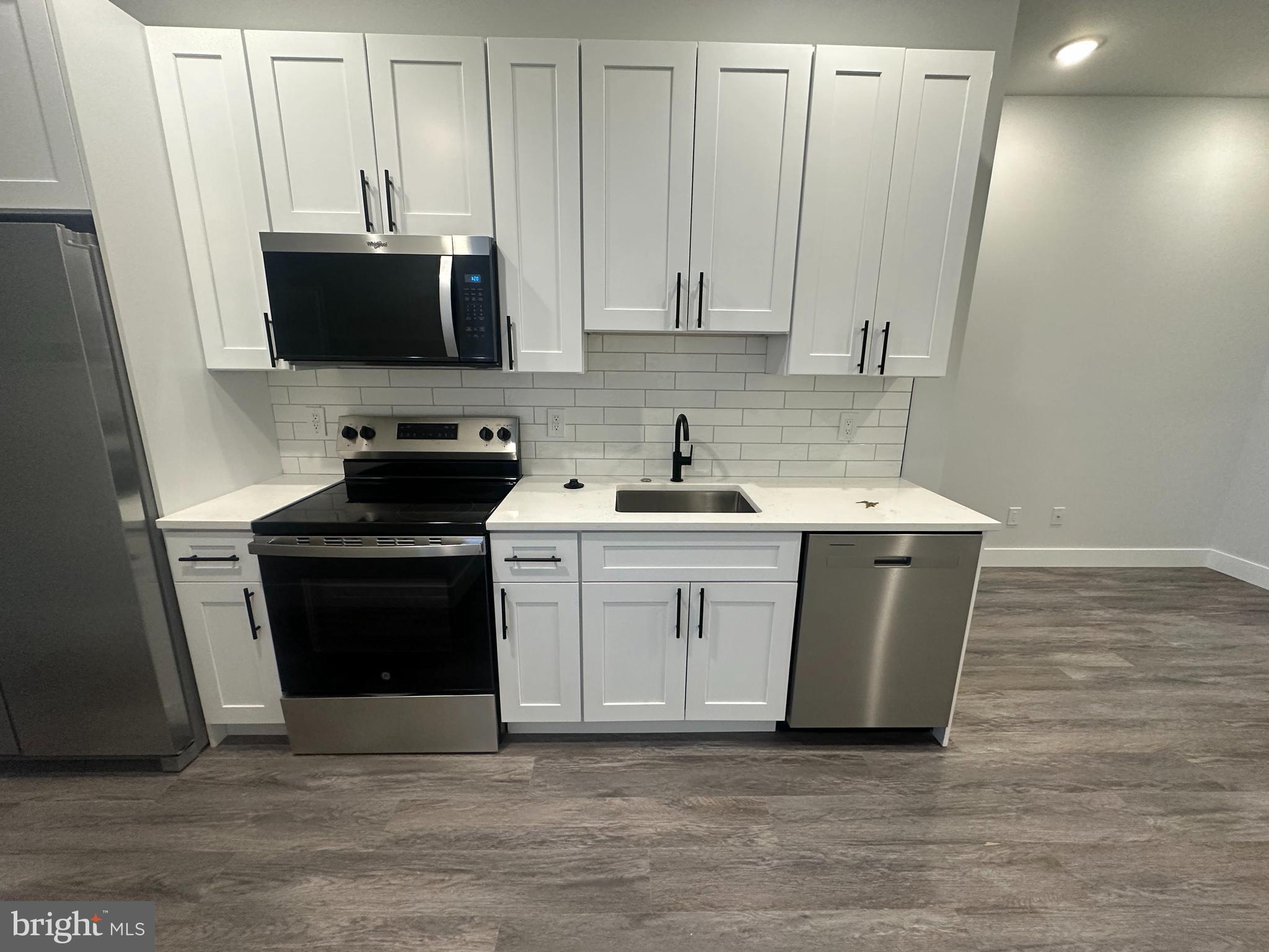 a kitchen with a sink and a stove top oven