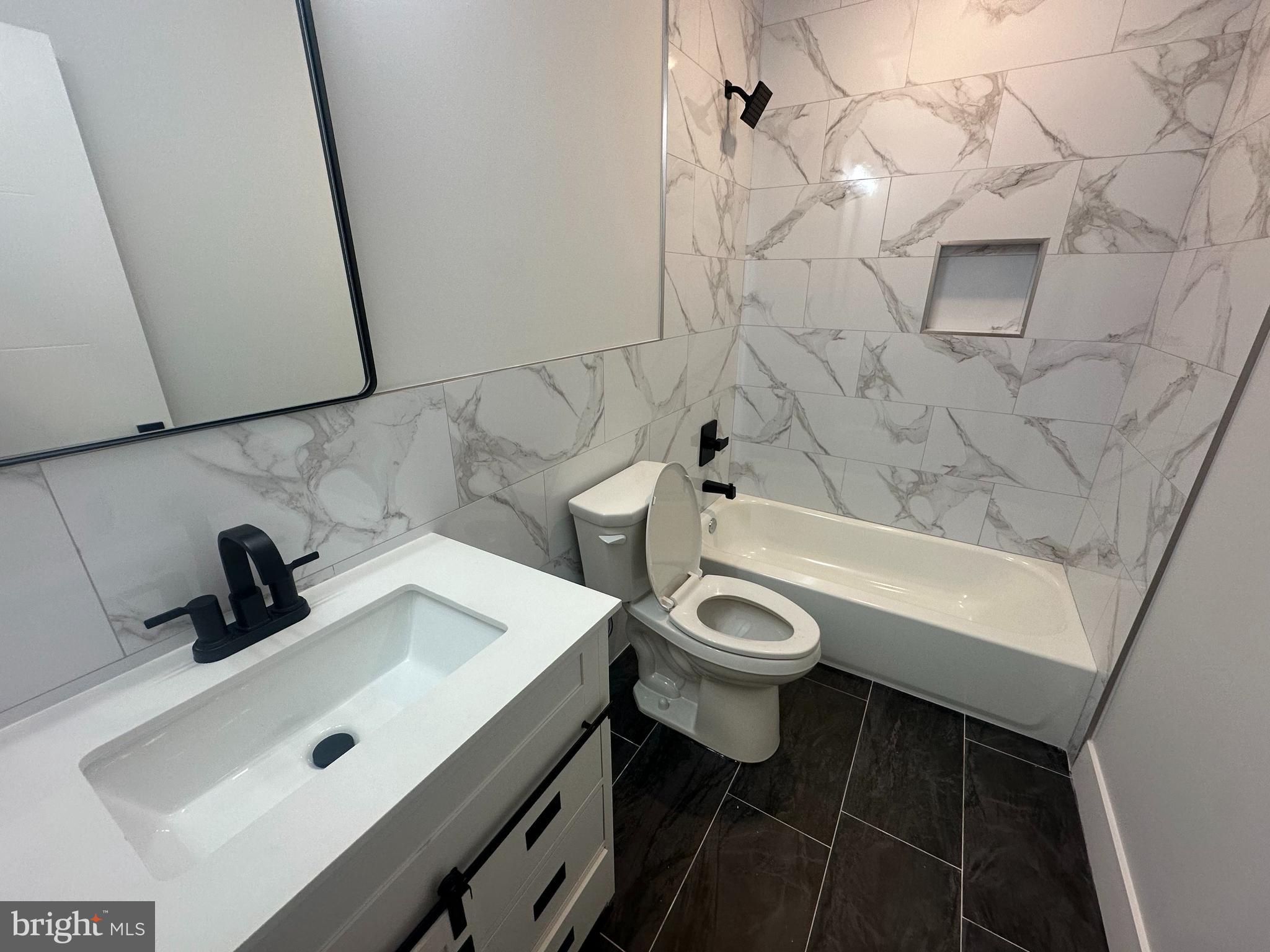 2120 North 7th Street, Unit 3 Philadelphia, PA 19122 - Photo 4 of 9 a bathroom with a sink a toilet and shower