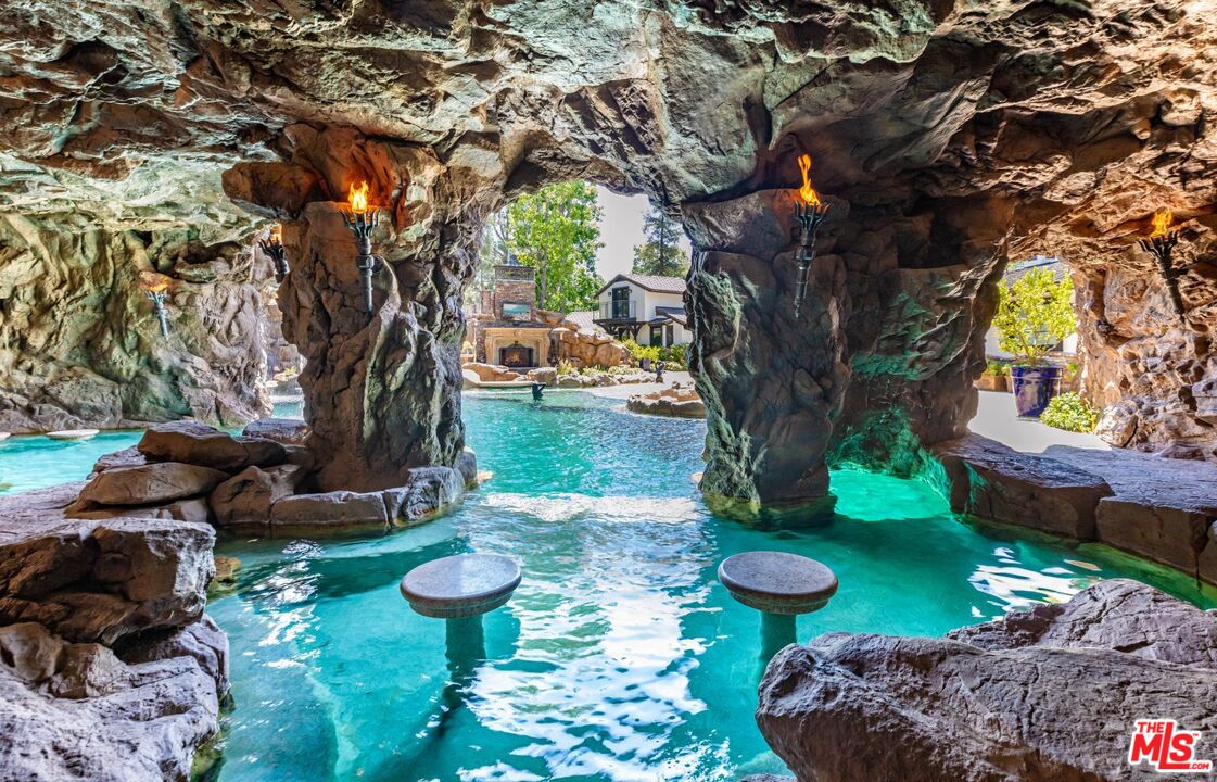 5841 Round Meadow Road Hidden Hills, CA 91302 - Photo 20 of 33 a view of a backyard with plants and a table and chairs
