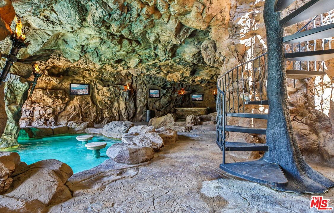 5841 Round Meadow Road Hidden Hills, CA 91302 - Photo 21 of 33 a backyard of a house with barbeque oven table and chairs
