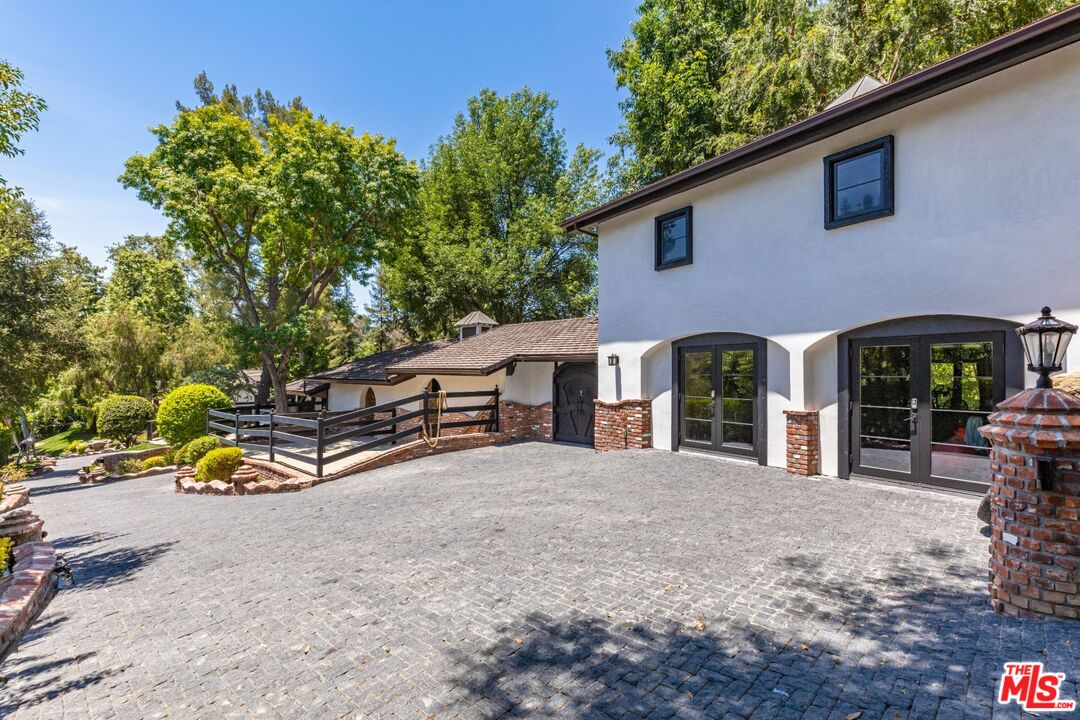 5841 Round Meadow Road Hidden Hills, CA 91302 - Photo 26 of 33 a view of a house with backyard and sitting area