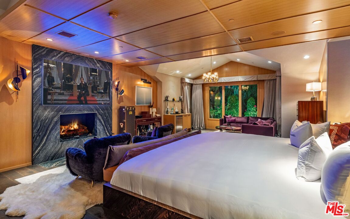 5841 Round Meadow Road Hidden Hills, CA 91302 - Photo 32 of 33 a bed room with a bed and a fireplace