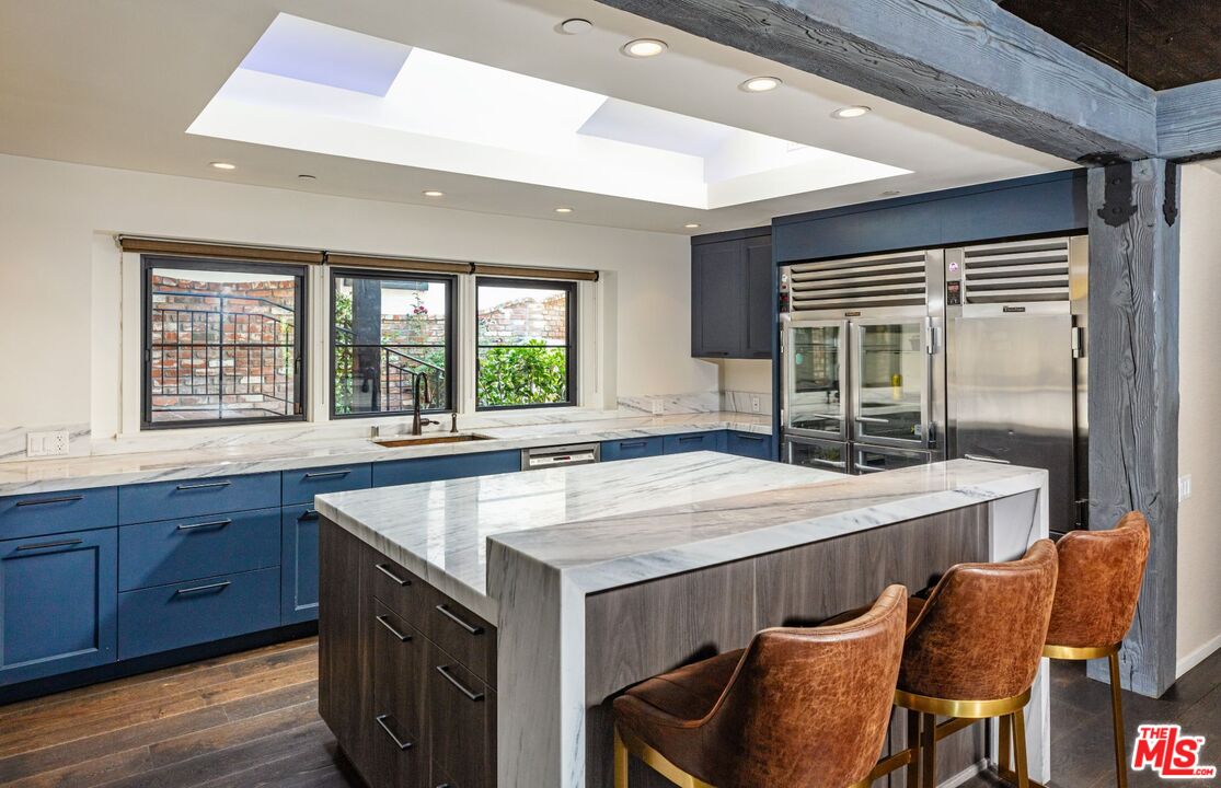 5841 Round Meadow Road Hidden Hills, CA 91302 - Photo 9 of 33 a kitchen with granite countertop a stove a sink and a refrigerator