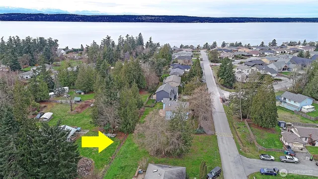 an aerial view of a house with a swimming pool outdoor seating and yard