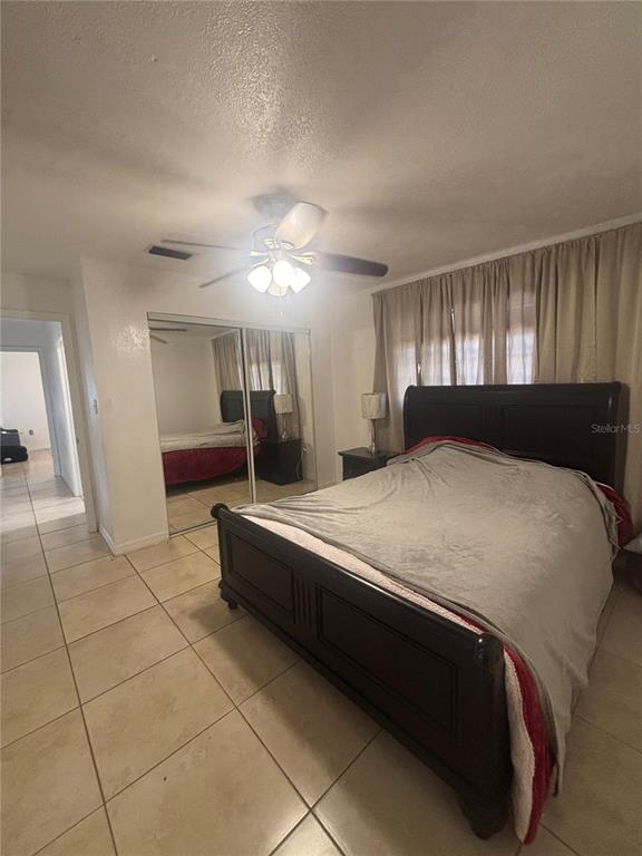 14208 Mayer Avenue Hudson, FL 34669 - Photo 12 of 29 a bedroom with a bed and a large window