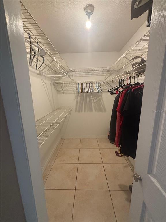 14208 Mayer Avenue Hudson, FL 34669 - Photo 14 of 29 a view of walk in closet with clothes and shoes