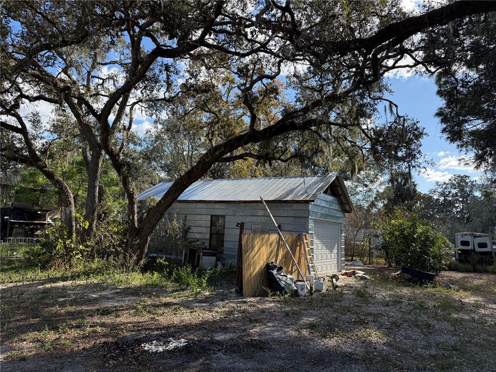 14208 Mayer Avenue Hudson, FL 34669 - Photo 17 of 29 a view of a barn with large trees