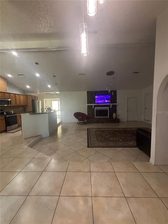 14208 Mayer Avenue Hudson, FL 34669 - Photo 5 of 29 a kitchen with stainless steel appliances kitchen island granite countertop a refrigerator and a counter top