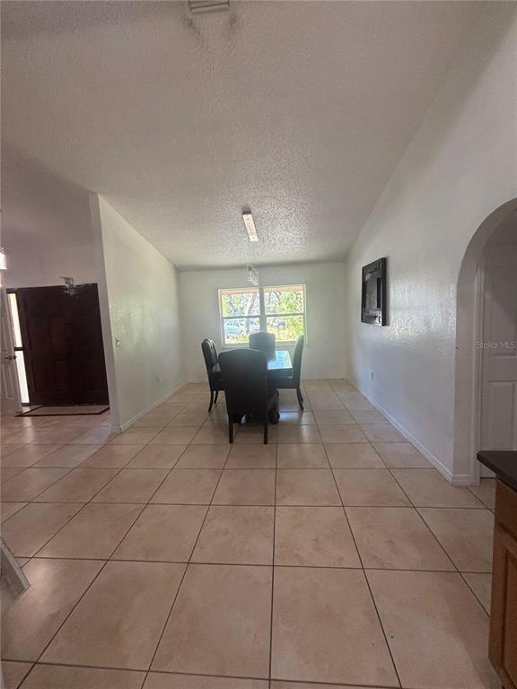 14208 Mayer Avenue Hudson, FL 34669 - Photo 8 of 29 a living room with furniture a chandelier and a window