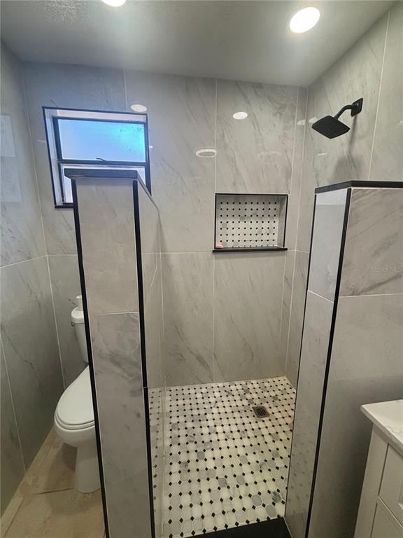 14208 Mayer Avenue Hudson, FL 34669 - Photo 10 of 29 a bathroom with a shower and a toilet