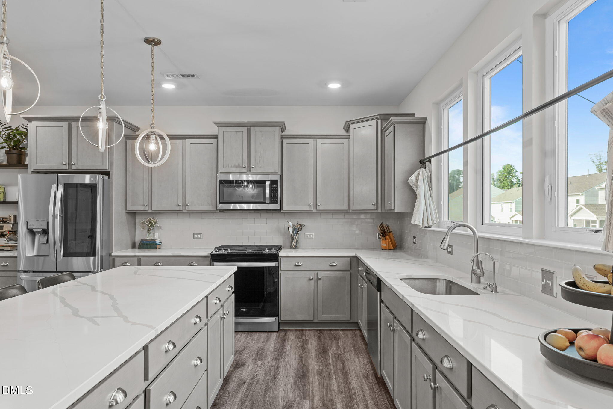 1400 Addison Lk Street Fuquay-Varina, NC 27526 - Photo 11 of 35 a kitchen with a sink dishwasher a stove a washer and dryer with kitchen island