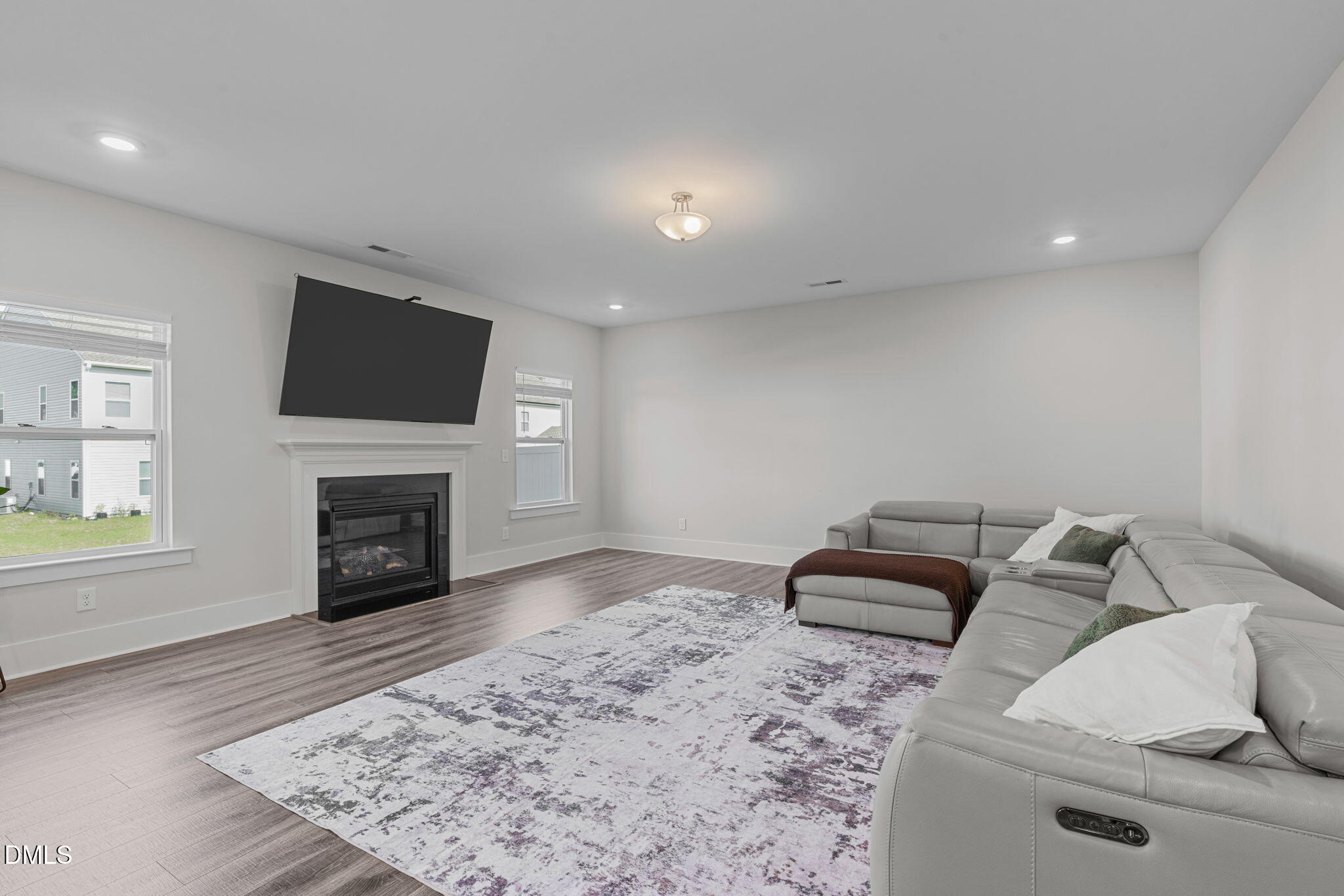 1400 Addison Lk Street Fuquay-Varina, NC 27526 - Photo 12 of 35 a living room with furniture a fireplace and a flat screen tv