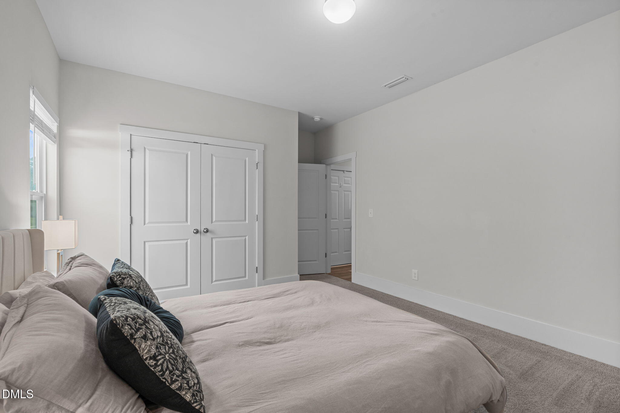 1400 Addison Lk Street Fuquay-Varina, NC 27526 - Photo 16 of 35 a bedroom with a bed and a painting on the wall