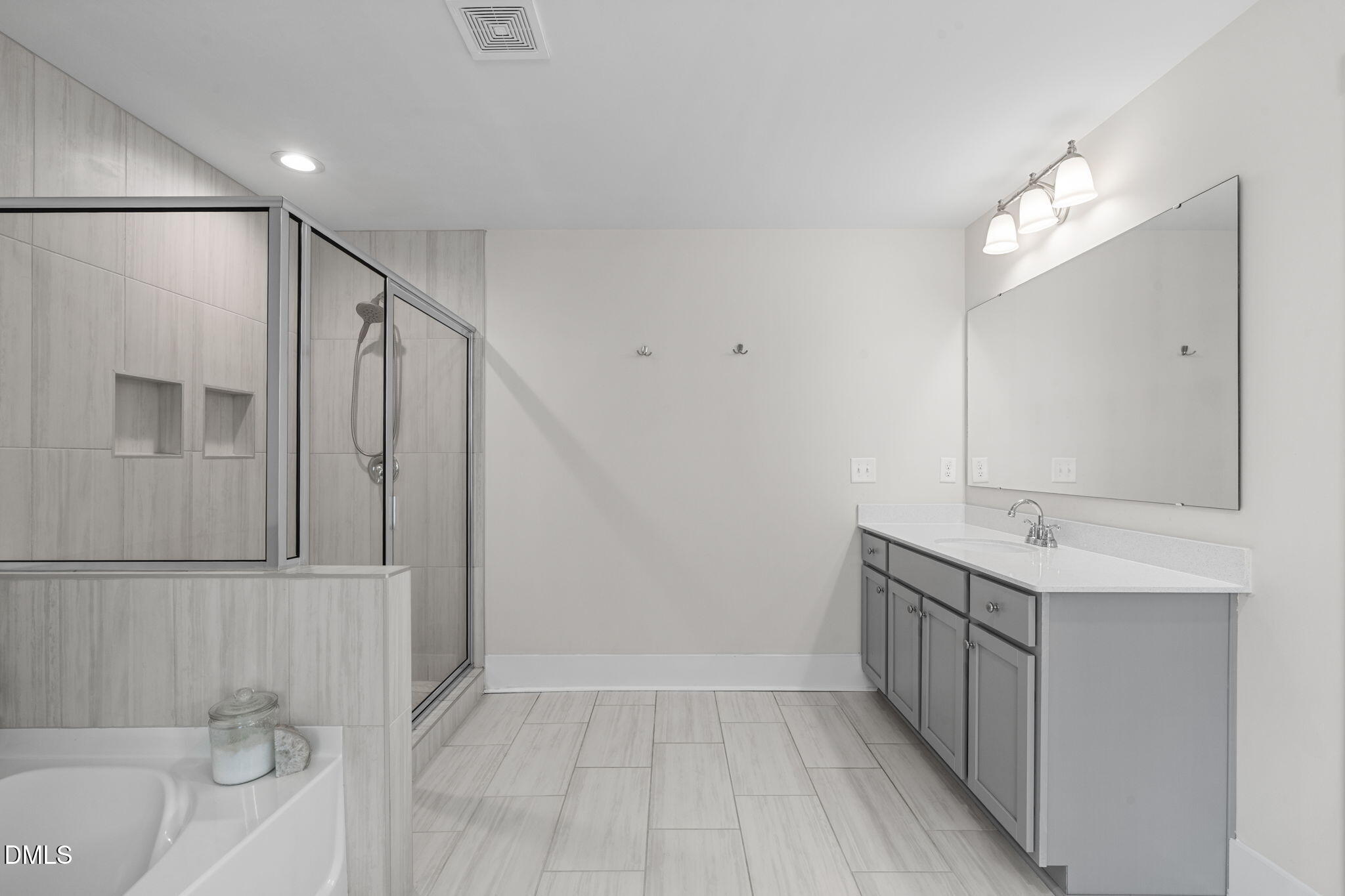 1400 Addison Lk Street Fuquay-Varina, NC 27526 - Photo 19 of 35 a bathroom with a sink a mirror and a shower