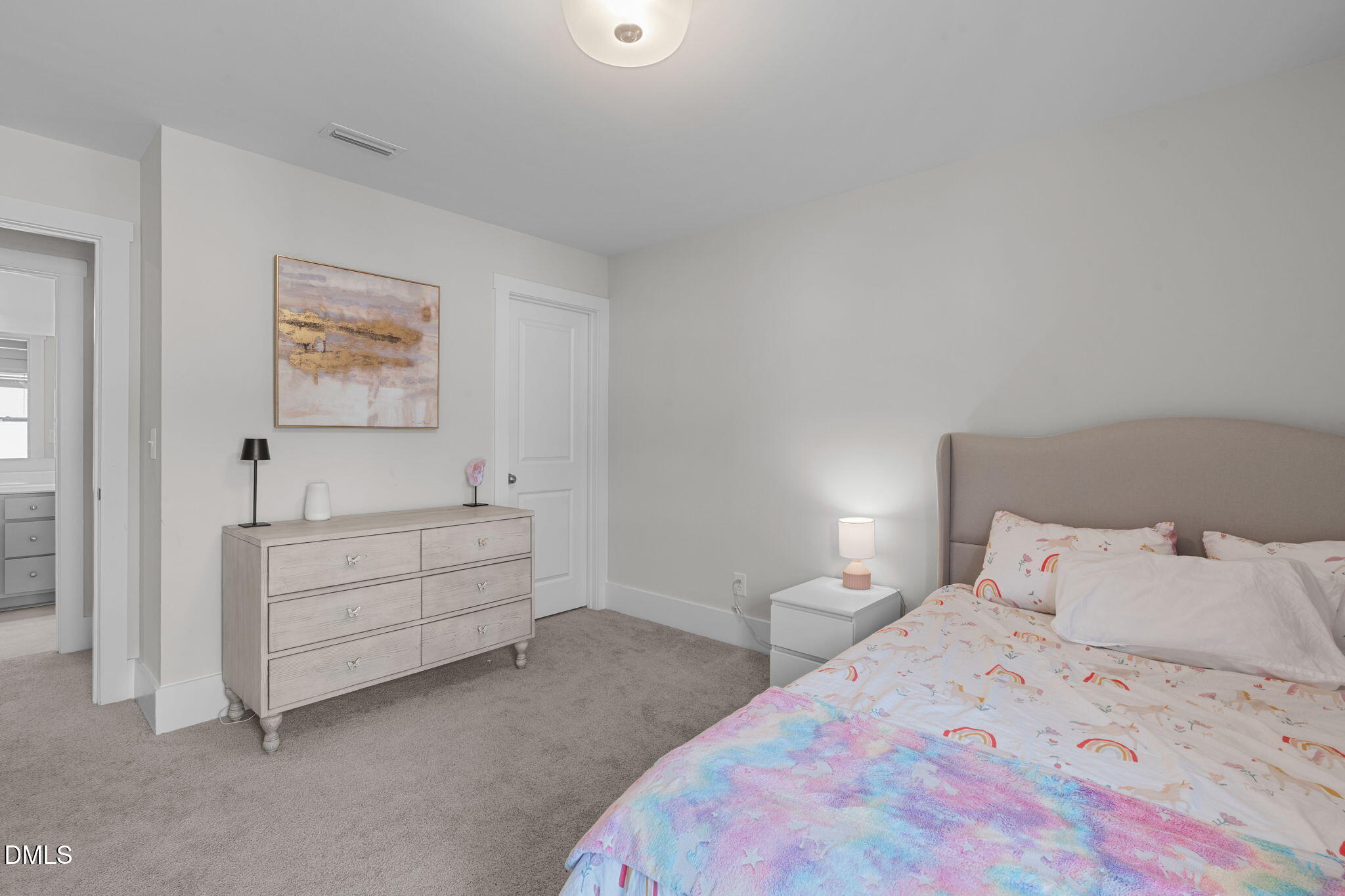 1400 Addison Lk Street Fuquay-Varina, NC 27526 - Photo 25 of 35 a bedroom with a bed and a lamp on dresser