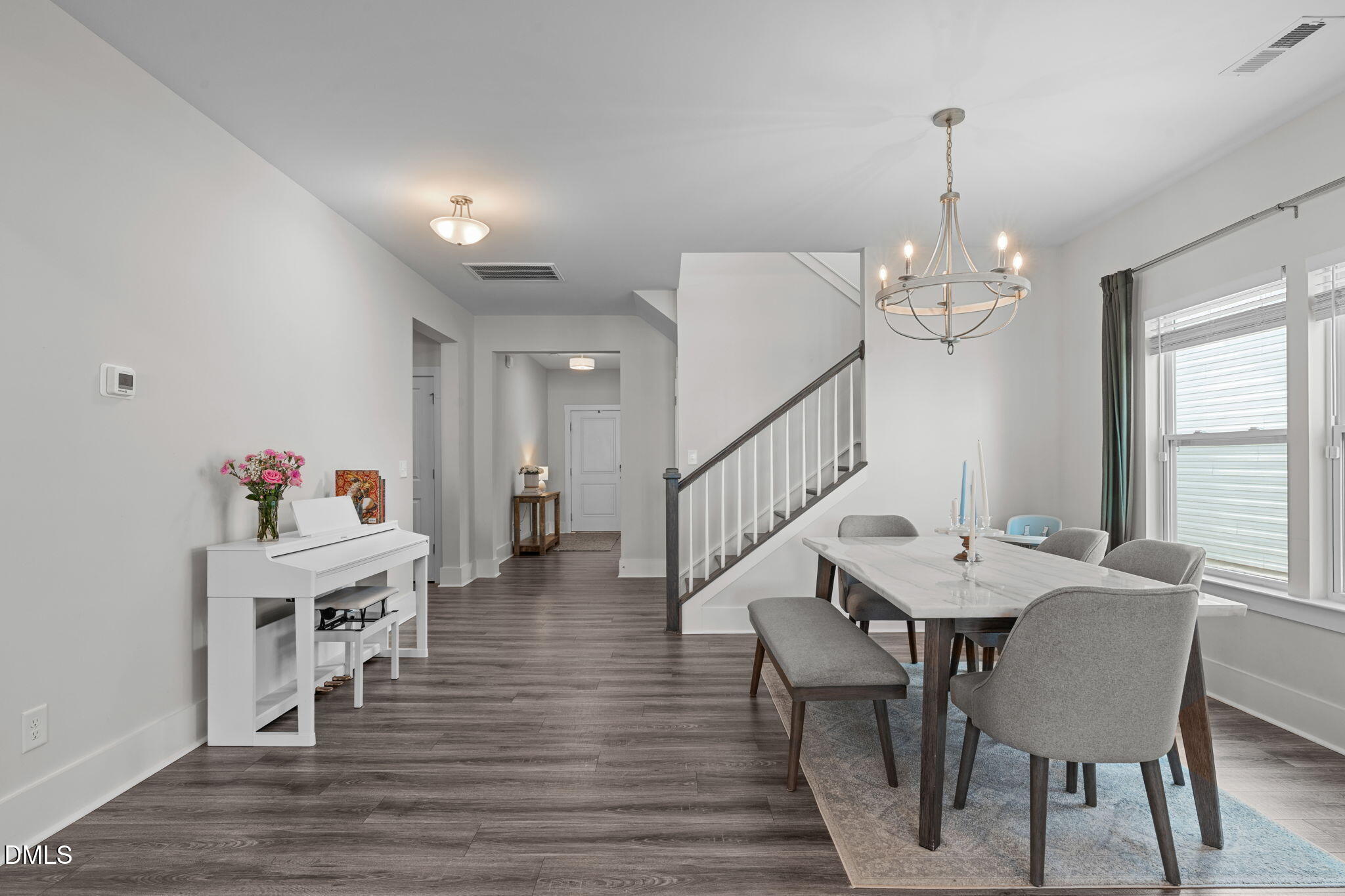 1400 Addison Lk Street Fuquay-Varina, NC 27526 - Photo 5 of 35 a view of a dining room with furniture a chandelier and wooden floor