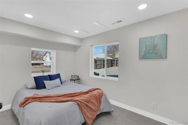 a bedroom with a large bed and a window