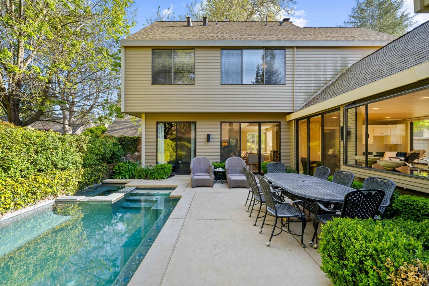 a view of a house with backyard sitting area and garden