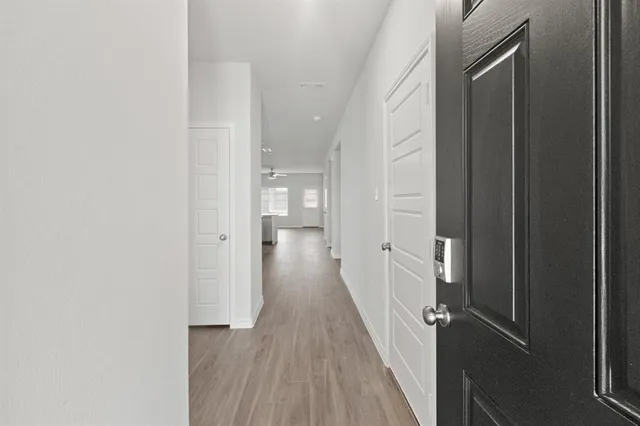a view of a hallway with wooden floor