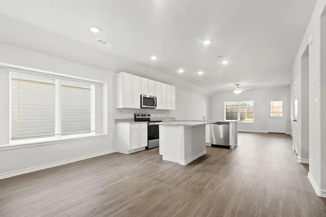 a view of kitchen with window and wooden floor