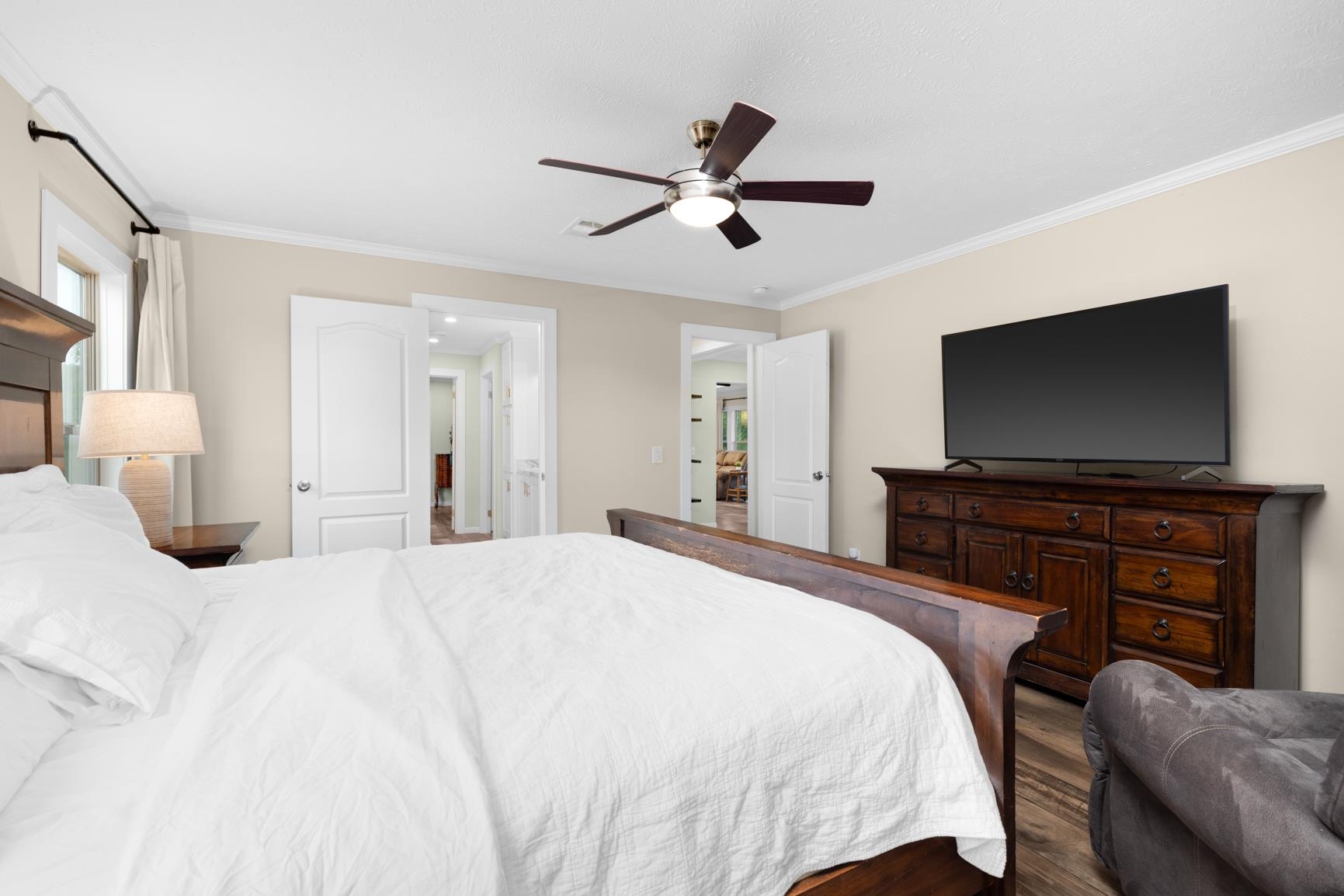 4044 Beaver Creek Road Mason, TN 38049 - Photo 13 of 36 Bedroom with ornamental molding, wood finished floors, a ceiling fan, and ensuite bath