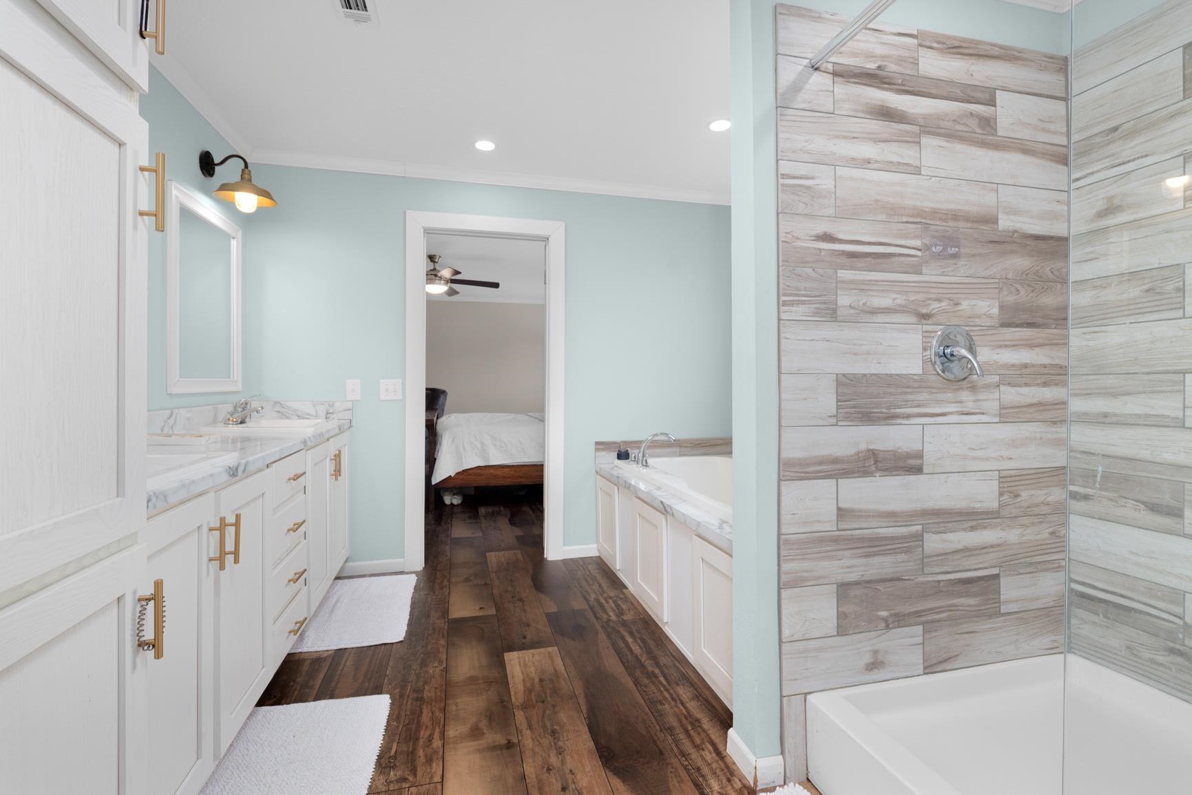 4044 Beaver Creek Road Mason, TN 38049 - Photo 16 of 36 Full bathroom featuring a bathtub, vanity, wood finished floors, ceiling fan, and ornamental molding