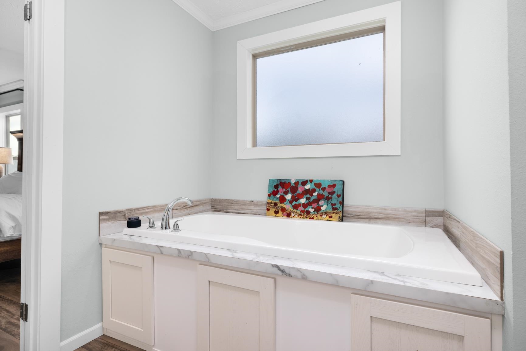 4044 Beaver Creek Road Mason, TN 38049 - Photo 17 of 36 Bathroom with crown molding, a bath, and wood finished floors