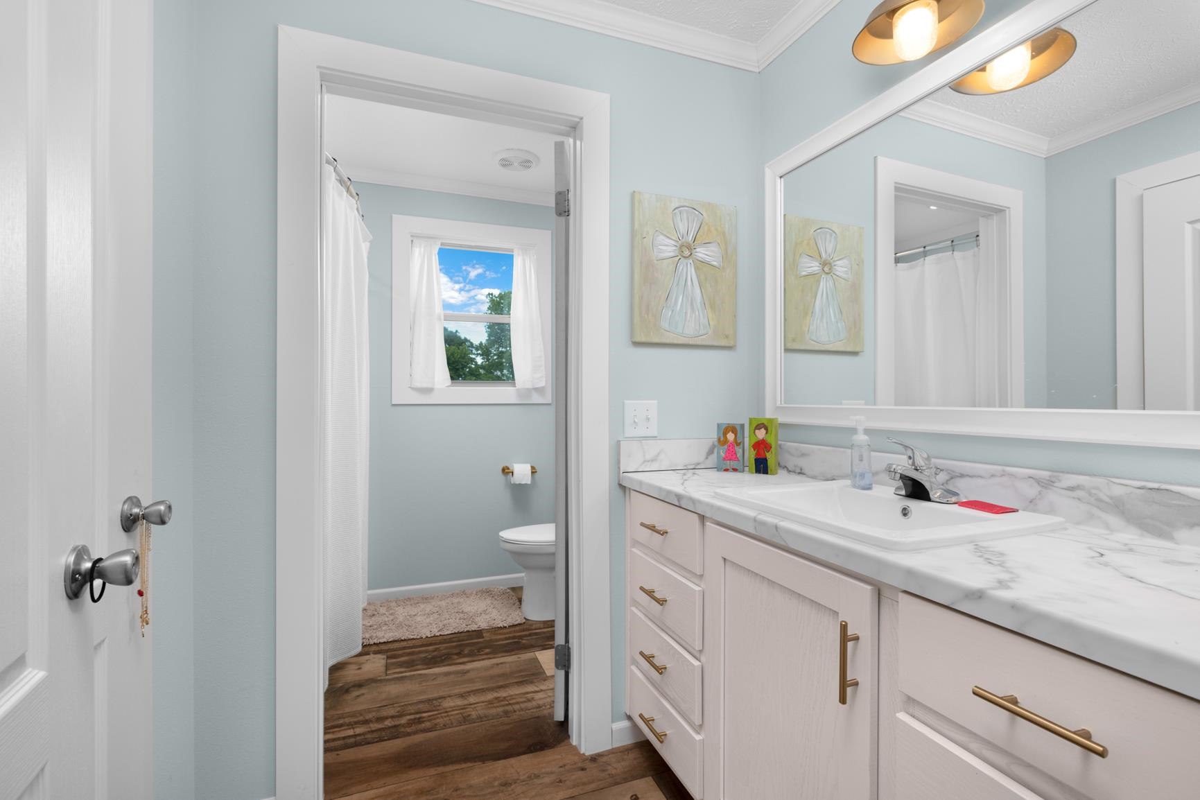 4044 Beaver Creek Road Mason, TN 38049 - Photo 27 of 36 Bathroom featuring vanity, toilet, wood finished floors, crown molding, and baseboards
