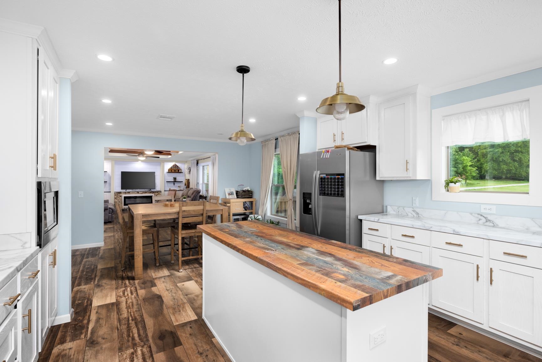 4044 Beaver Creek Road Mason, TN 38049 - Photo 36 of 36 Kitchen with wooden counters, stainless steel refrigerator with ice dispenser, open floor plan, white cabinetry, and recessed lighting