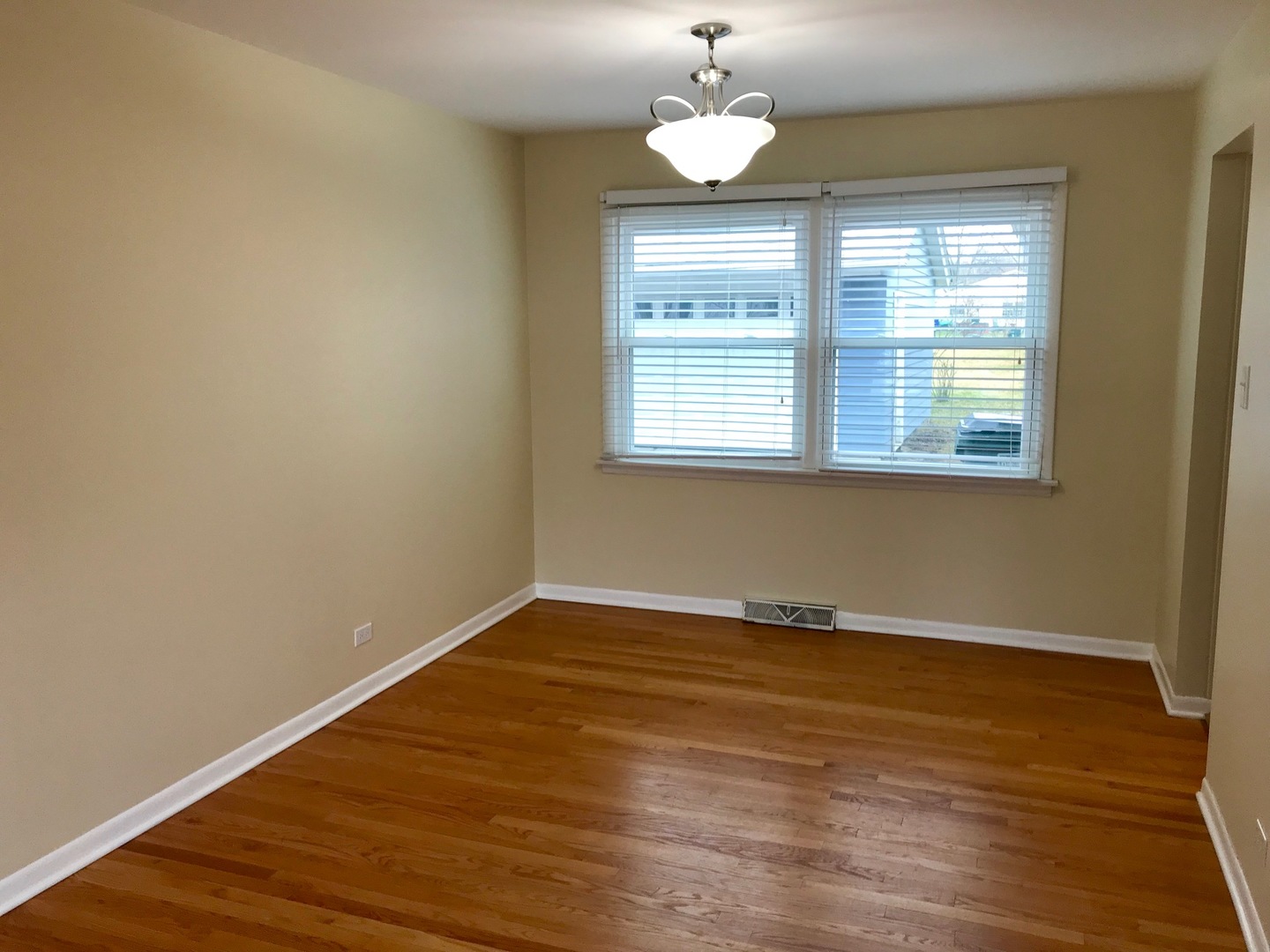 1223 Evergreen Road Homewood, IL 60430 - Photo 8 of 34 an empty room with wooden floor and window