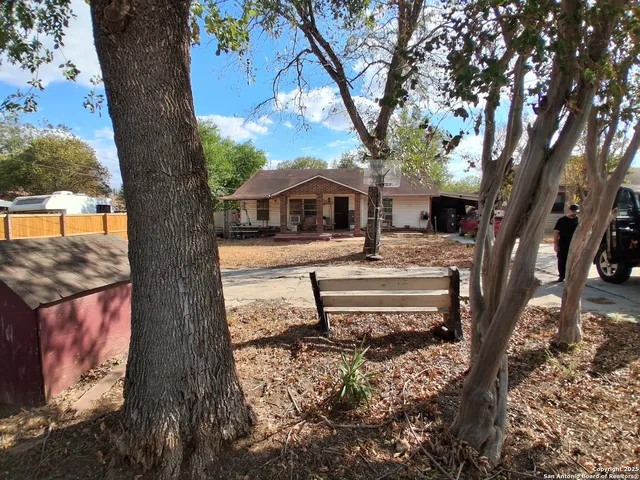 a view of a house with a yard from a tree