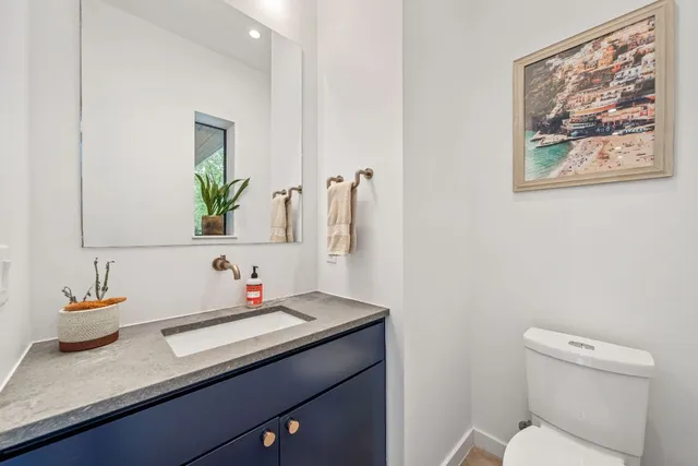 a large white kitchen with stainless steel appliances