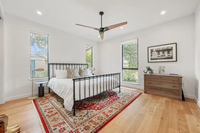 a view of a hallway with wooden floor and a rug