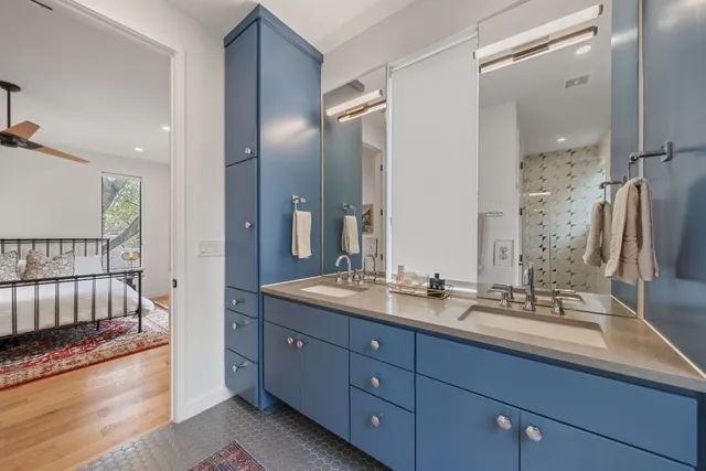 a bathroom with a double vanity sink and a mirror