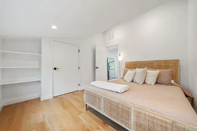 a spacious bedroom with a bed and window