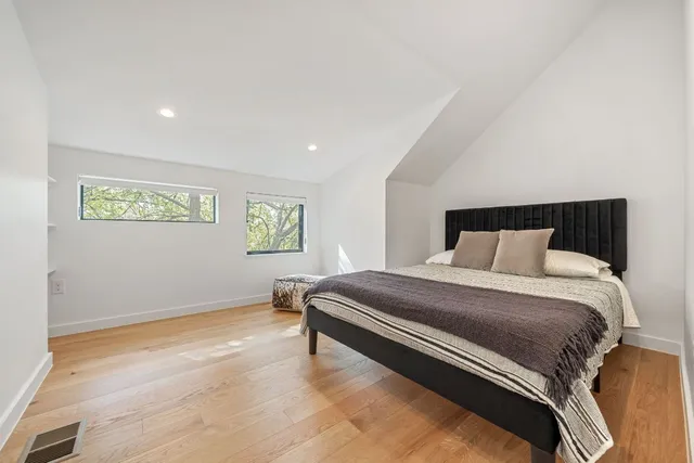 a large white bed in a white room