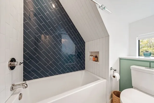 a view of bathroom with a sink and mirror next to a window