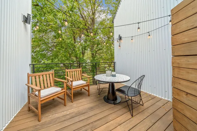 a view of a balcony with table and chairs