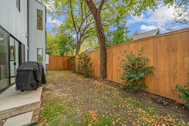 a view of a back yard with potted plants