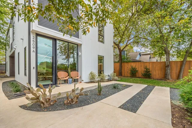 a view of a house with backyard and sitting area