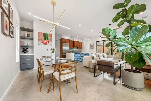 a living room with furniture a potted plant and a book