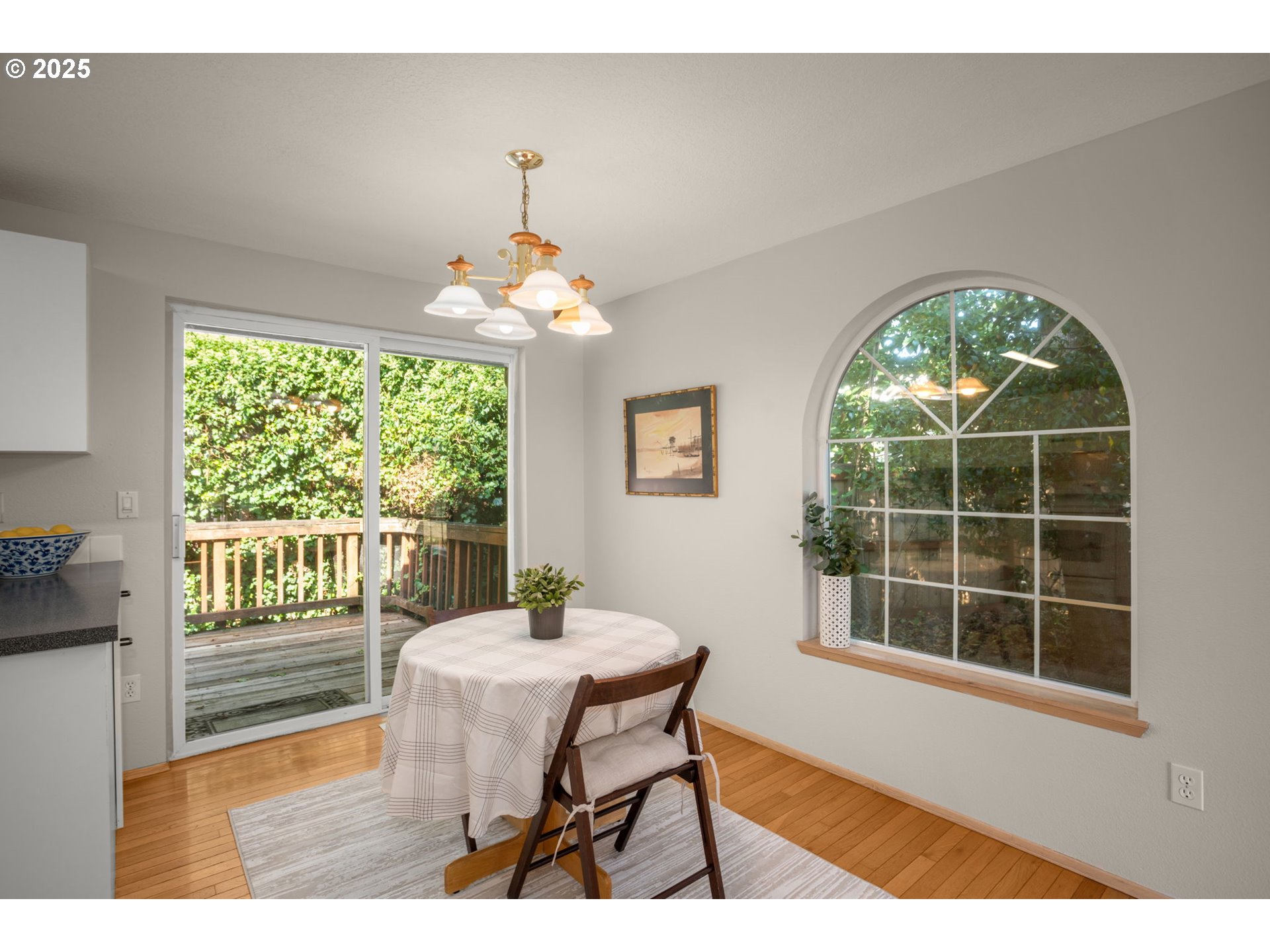 8123 Southwest Hearthside Court Portland, OR 97223 - Photo 7 of 19 a dining room with furniture a chandelier and wooden floor
